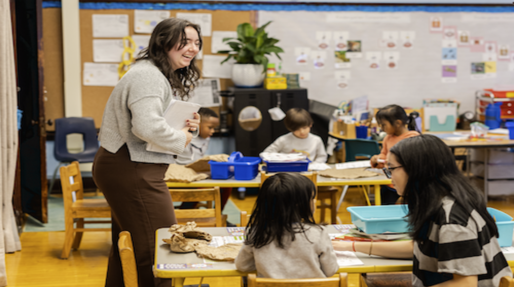 A woman in a classroom teaching kids